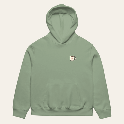 Sage Nothing Urgent hoodie laid flat, front view with small heart mug chest print