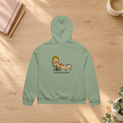 Sage Nothing Urgent hoodie back in a slow-morning desk flatlay mockup with notebook and plant; props not included