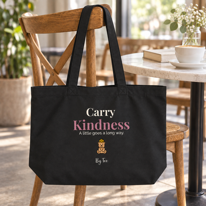 Carry Kindness Tote — Black — front artwork in a lifestyle mockup