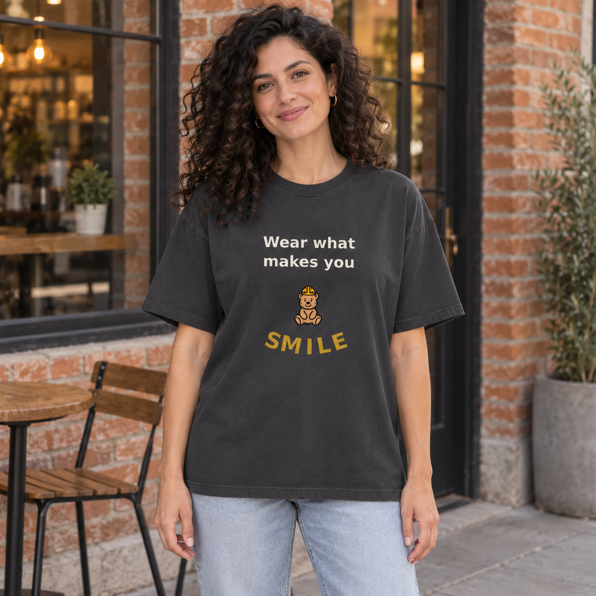 Wear What Makes You Smile Oversized Tee — Faded Black — front artwork in a lifestyle mockup