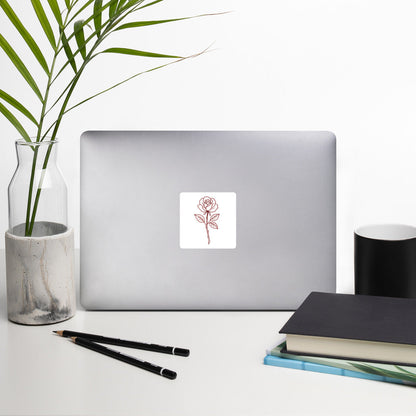 Rose Sticker by By Tee, on a laptop in a neutral workspace with greenery