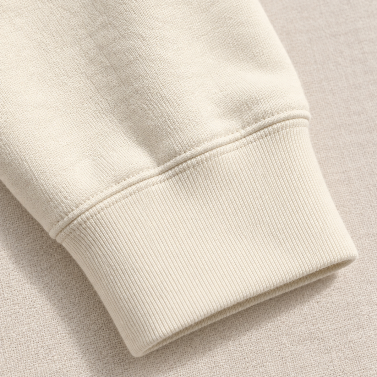 Soft but Strong bone crewneck — cuff detail mockup.