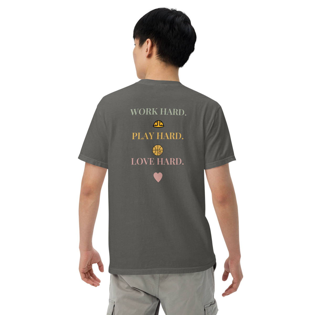 Model wearing the Pepper Work Hard Icons relaxed-fit T-shirt, showing the back slogan and helmet, basketball with a bear-head emblem, and heart.
