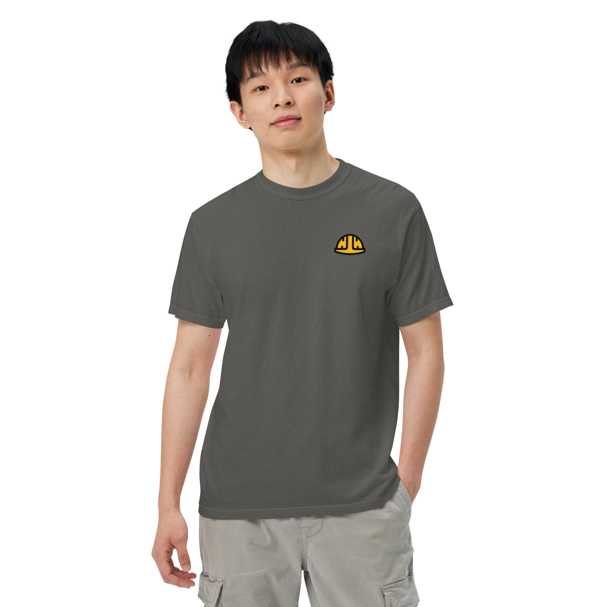 Model wearing the Pepper Work Hard Icons relaxed-fit T-shirt with the original yellow helmet on the wearer-left chest.