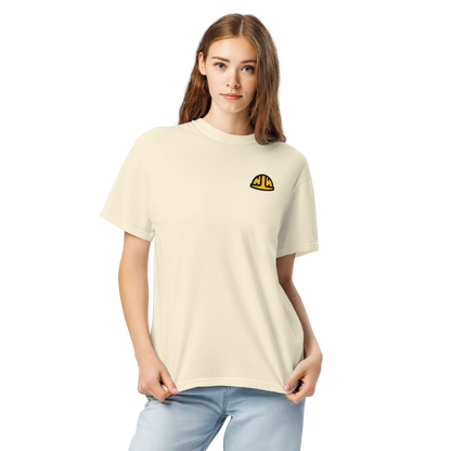Model wearing the Ivory Work Hard Icons relaxed-fit T-shirt with the original yellow helmet on the wearer-left chest.