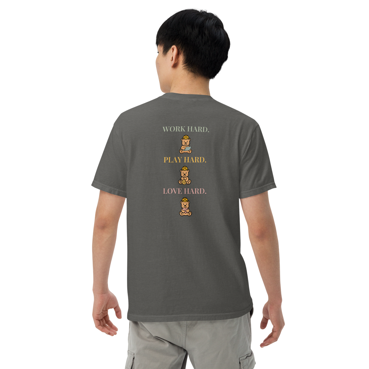 Model wearing the Pepper Work Hard Three Bears relaxed-fit T-shirt, showing the back slogan and three helmeted bears with a laptop, basketball, and heart.